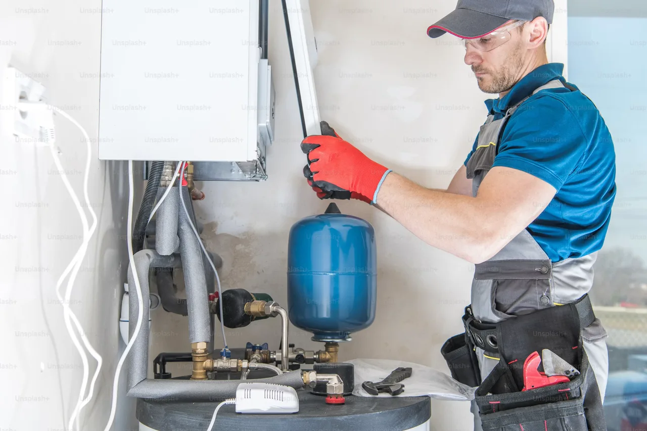 Technician inspecting a water heating system